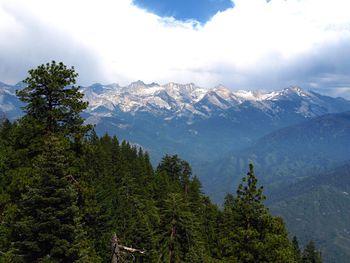 Scenic view of mountains against cloudy sky