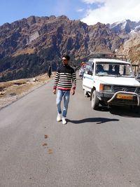 Rear view of man on road against mountain