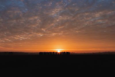 Scenic view of silhouette land against sky during sunset