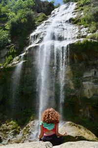 Woman looking at waterfall