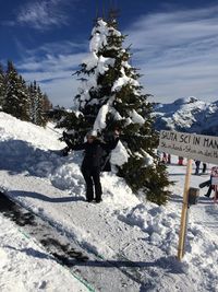 Full length of woman standing on snow covered mountain