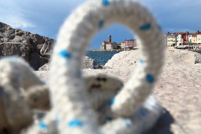 Close-up of water drops on beach against buildings