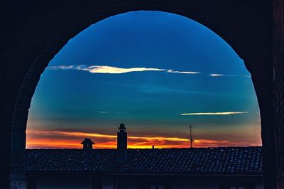 Silhouette building against sky during sunset