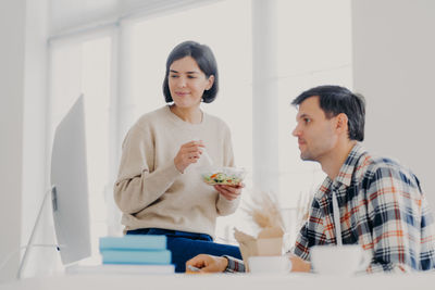 Couple using computer on table