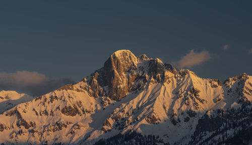 Scenic view of snowcapped mountains against sky during sunset