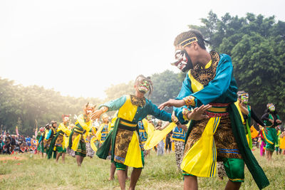 Young couple in traditional clothing against sky