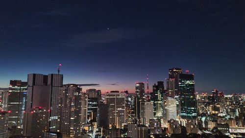 Illuminated buildings in city at night