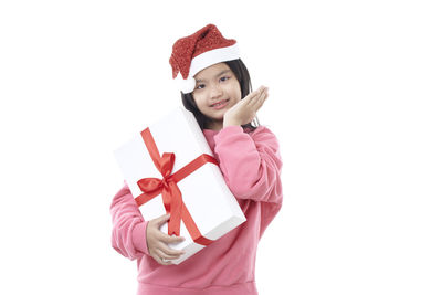 Portrait of girl wearing hat against white background