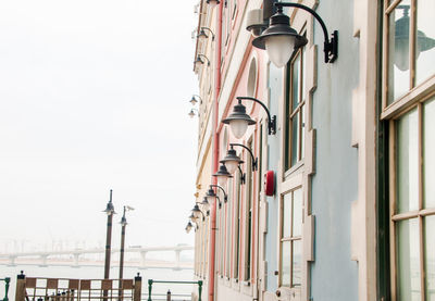 Low angle view of street light against building