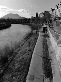 River amidst buildings in city against sky