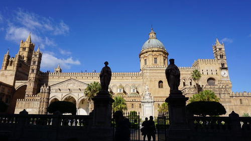 Low angle view of historical building against blue sky