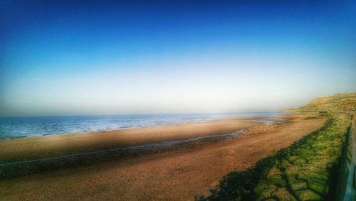 Scenic view of beach against clear sky