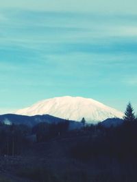 Scenic view of mountains against blue sky