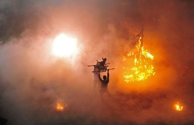 High angle view of people fighting by fire