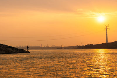 Scenic view of sea against orange sky