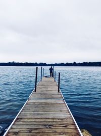 Pier over lake against sky