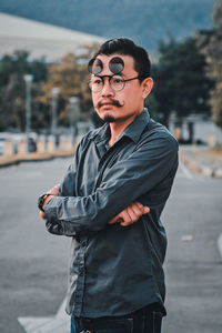 Man wearing eyewear while standing in city