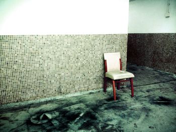 Empty chairs against wall