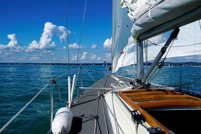 Sailboat sailing in sea against sky