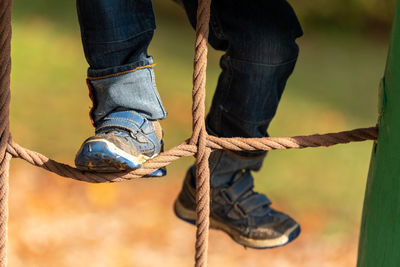 Low section of man standing on rope