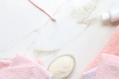 Directly above shot of toiletries on white marble table