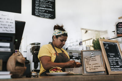 Woman preparing food in cafe