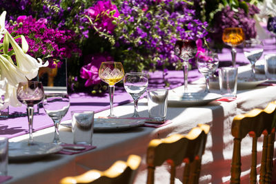 Laid celebration dinner table with empty beautiful tableware for holiday outdoor in summer sun day.