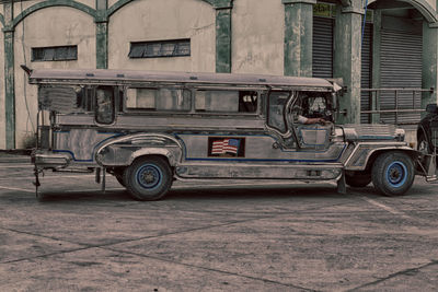 Vintage car on street against buildings in city