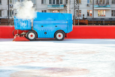 A special blue ice cleaning machine polishes the ice rink of the stadium.