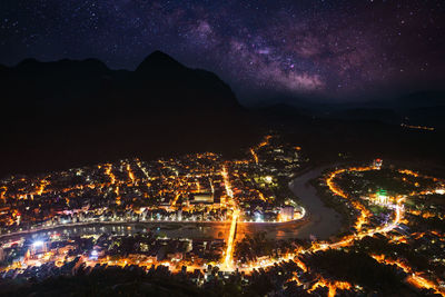 High angle view of illuminated buildings in city at night