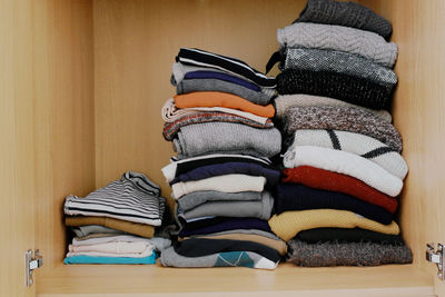 Stack of clothes in shelf at home