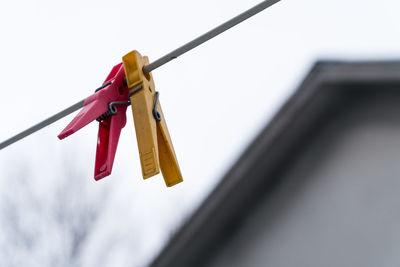 Clothes clips hanging on the line in winter