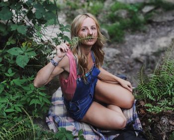 Portrait of smiling young woman sitting outdoors