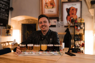 Portrait of smiling mid adult man at restaurant table