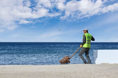 Man standing on beach against sky