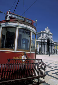 Cable car at praca do comercio against clear blue sky in city