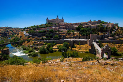 Castle on mountains against clear sky