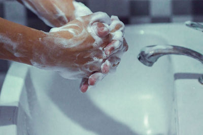 Close-up of human hand in bathroom