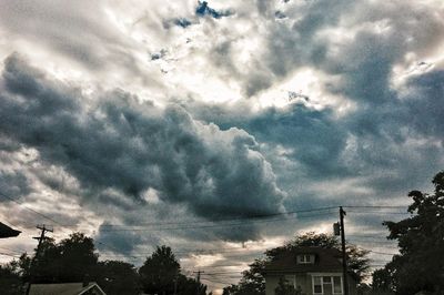 Low angle view of building against cloudy sky