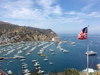 Scenic view of harbor with american flag in foreground