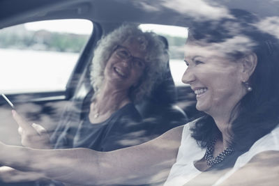 Happy senior women enjoying road trip