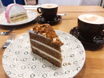 Coffee cup and cake on table