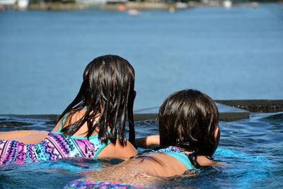 Girls swimming in lake