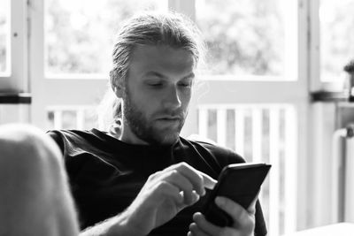 Man using mobile phone at home