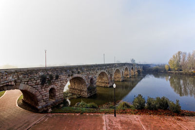 Bridge over river against clear sky