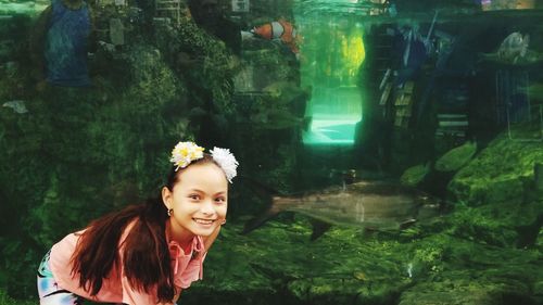 Portrait of smiling girl against water