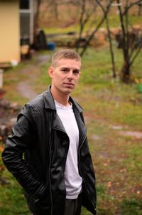 Portrait of young man standing on land