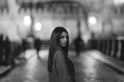 Young woman with illuminated hair at night