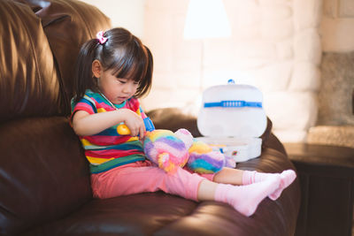 Girl playing with toy at home