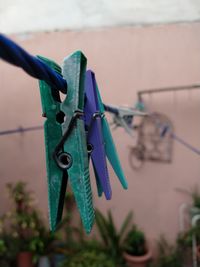 Close-up of clothes hanging on rope against wall